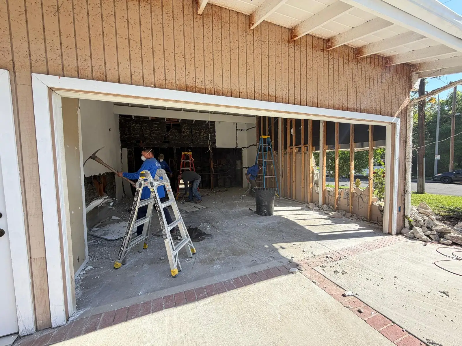 A skilled worker adjusts a garage door